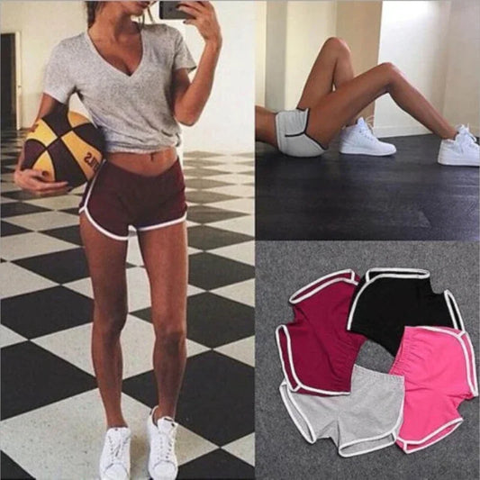 Person wearing athletic shorts with a checkered floor background, showing different pairs of shorts.