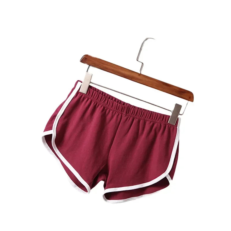 Maroon shorts with white trim on a wooden hanger against a white background