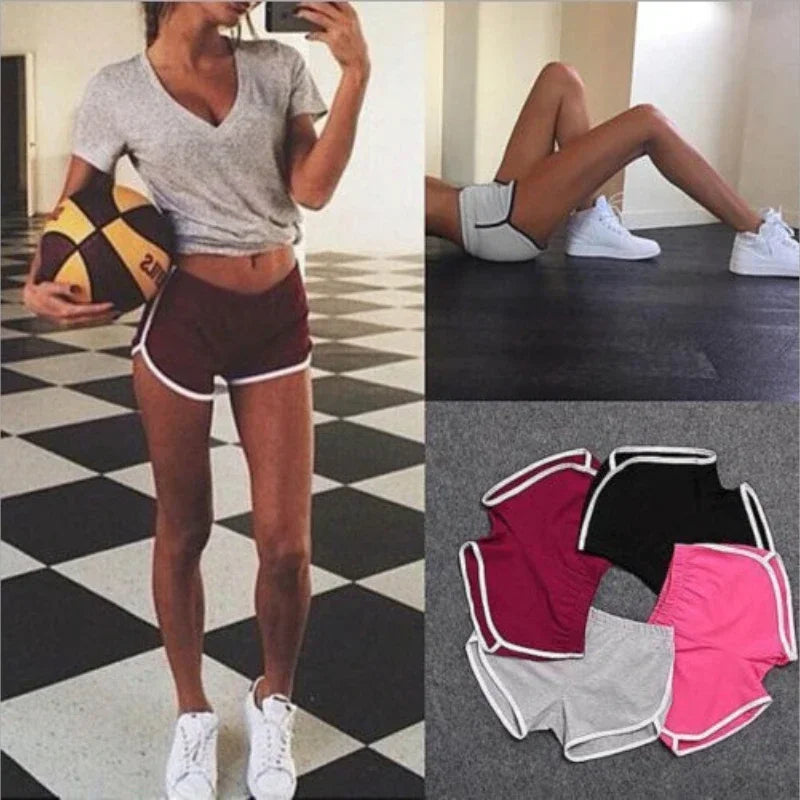 Person wearing athletic shorts with a checkered floor background, showing different pairs of shorts.