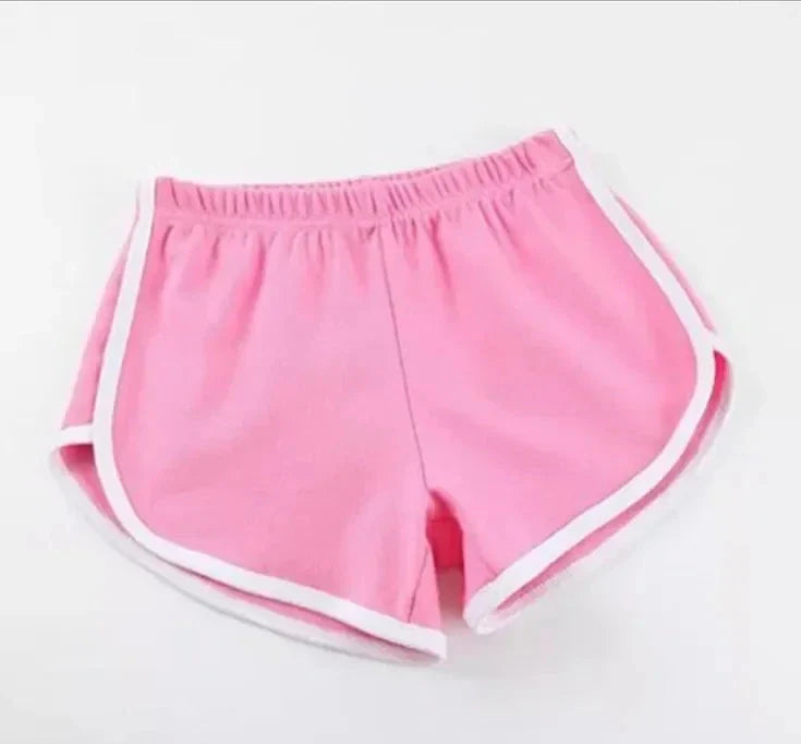 Pink shorts with white trim on a light gray background