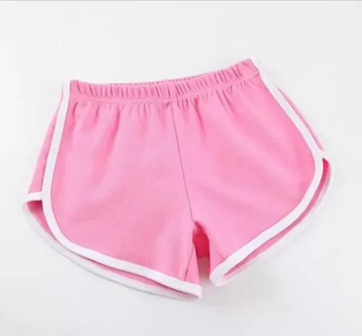 Pink shorts with white trim on a light gray background