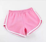 Pink shorts with white trim on a light gray background