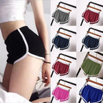 Black athletic shorts with white trim on a person, followed by a grid of colorful shorts on hangers.