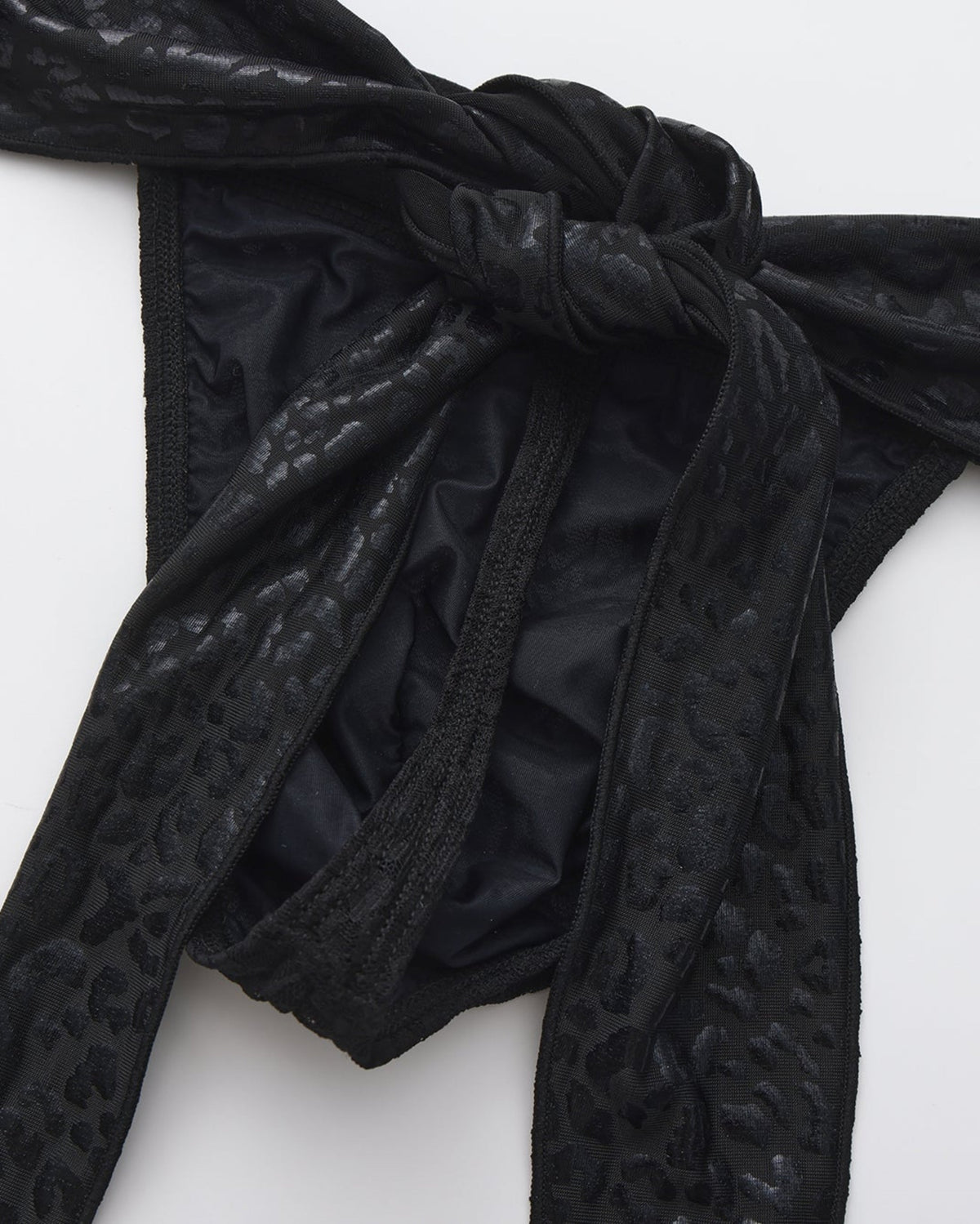 Men's black lace thong with leopard-pattern scarf ties.