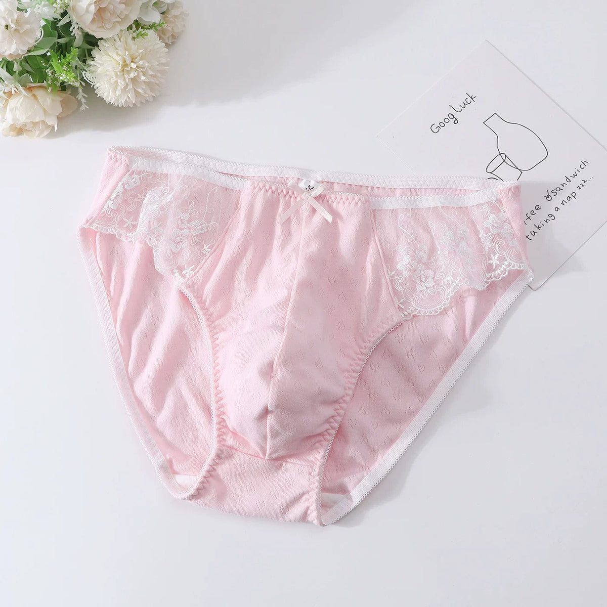 Men's jacquard-textured briefs with lace hip inserts and a front bow.