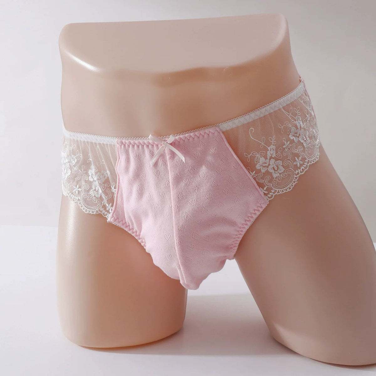 Men's jacquard-textured briefs with lace hip inserts and a front bow.