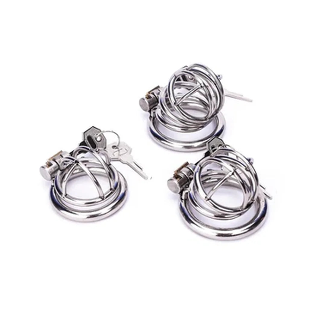 Three silver-tone Metal Chastity Cages in different sizes, shown with round base rings and keys.