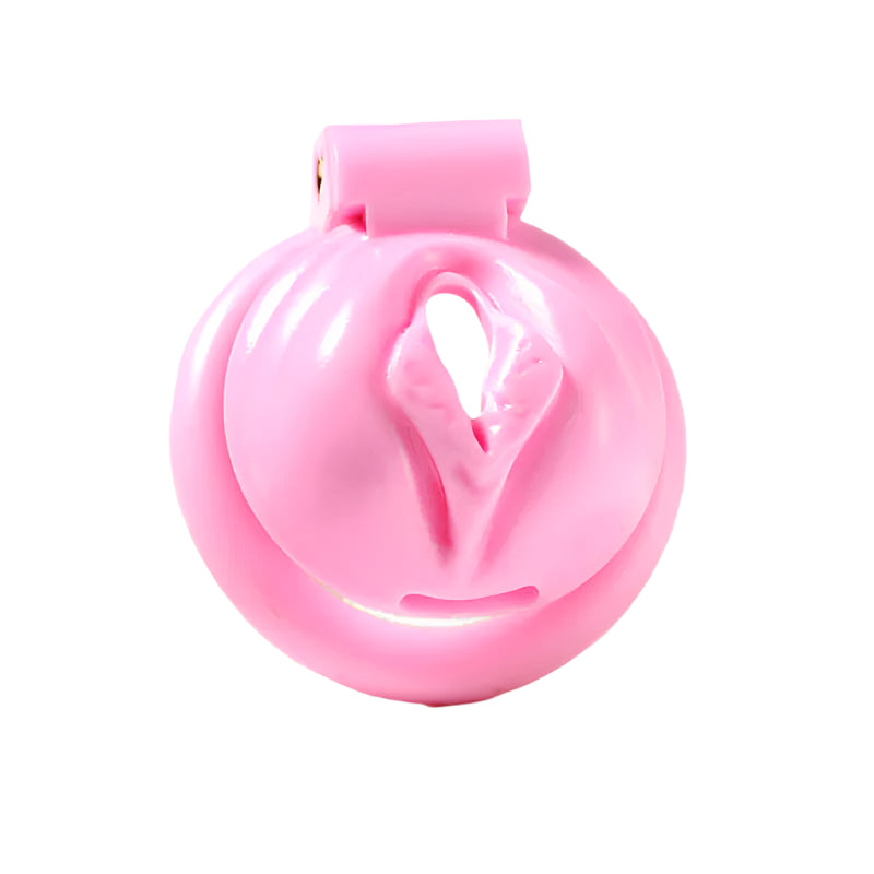 A pink, pussy-shaped male chastity cage made from ABS plastic, featuring a heart-shaped design and snap-in base rings for adjustment.